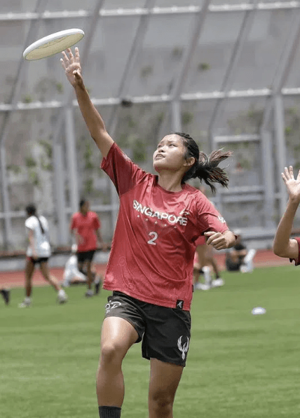 Player reaching up to catch a frisbee