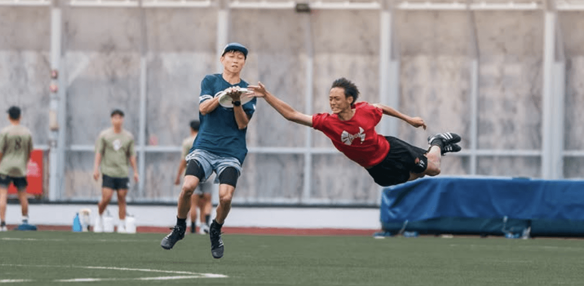 Ultimate frisbee player laying out for a catch
